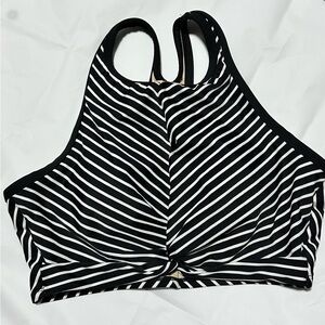 Medium Kona Sola black and white striped swim top.